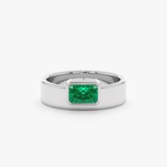 Geneva Unveil your bold style with the Off-Center Emerald Statement Ring. This eye-catching ring showcases a vibrant natural emerald, the May birthstone, in a captivating off-center setting. Crafted in lustrous 14k or 18k solid gold, the thick band adds a contemporary touch while maintaining minimalist elegance. - Handmade- Solid Gold- Natural Emerald- Total Emerald Carat Weight: 0.49 ctw- The Height of the Setting: 2.93 mm- Width of the Setting with the Band: 7.12 mm- The Width of the Band: 5.7 Modern Diamond Ring For May Birthstone, Modern May Birthstone Diamond Ring, Modern Green Rings With Prong Setting, Modern Baguette Cut Emerald Ring For May Birthstone, Modern Emerald Ring With Bezel Setting For Promise, Modern Emerald Cut May Birthstone Jewelry, Modern Green Jewelry With Prong Setting, Modern Emerald Ring With Baguette Cut, Modern Emerald Ring With Baguette Cut And Prong Setting