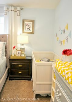 a baby's room is decorated in yellow and white