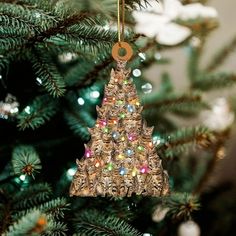 a christmas tree ornament hanging from the top of a pine tree