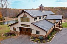 a large house with a metal roof in the country