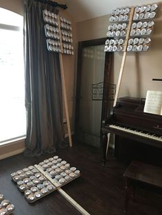 a piano and some cookies are on the floor in front of a window with curtains