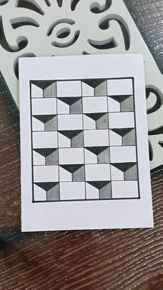 a piece of paper sitting on top of a table next to a cut out pattern