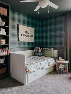 a bed room with a neatly made bed and a book shelf on the wall next to it