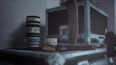 a stack of books sitting on top of a table next to a computer monitor and other items