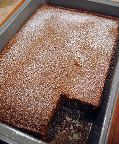 a square cake pan with some powdered sugar on top