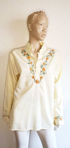 Beautiful orange embroidery.  Poly cotton blend. Manilla yellow.. long sleeve with hidden side pockets. Embroidery around cuff of sleeve. Button to mid chest. love an amazing vintage find. This is one. Perfect with some denim bell bottom. Affordable Yellow Embroidered Blouse, Affordable Orange Floral Embroidered Tops, Cheap Embroidered Yellow Blouse, Embroidery Boho, Orange Embroidery, Hippie Blouse, Yellow Long Sleeve, Womens Blouses, Bell Bottom