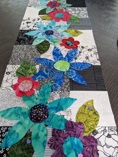 the table runner is decorated with colorful flowers