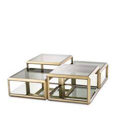 three glass and brass coffee tables on white background