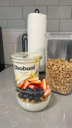 yogurt, granola and berries in a bowl on a counter