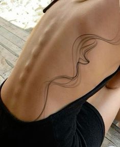 the back of a woman's body with wavy lines on it