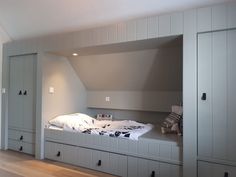 a bedroom with built in cabinets and a bed