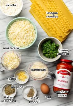 ingredients to make an italian pasta recipe laid out on a marble counter top, including eggs, parmesan cheese and seasonings