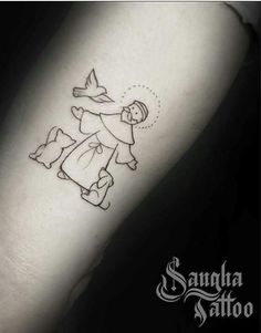 a small tattoo on the arm of a woman with an angel flying above her head