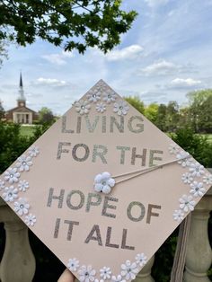 a graduation cap that says living for the hope of it all with flowers on it