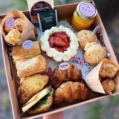 a box filled with different types of pastries and jams on top of each other