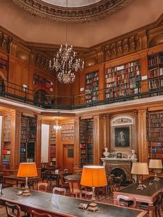 the library has many tables and chairs with lamps on them