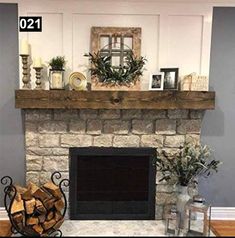 the fireplace is decorated with greenery and candles