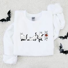 FREE SHIPPING On U.S. orders over $50.00! Use coupon code FREEOVER50 Ready for Spooky Season?! This Halloween Sweatshirt is exactly what you've been looking for! Our unisex heavy blend crewneck sweatshirt is pure comfort. These garments are made from polyester and cotton. This combination helps designs come out looking fresh and beautiful. The collar is ribbed knit, so it retains its shape even after washing. There are no itchy side seams on these sweaters. * 50% cotton, 50% polyester * Pre-shru White Long Sleeve T-shirt With Cat Design, White T-shirt With Cat Print For Fall, White Crew Neck Sweatshirt With Cat Design, White Crew Neck Sweatshirt With Cat Print, White Cat Design Top For Fall, Halloween Cat Print Crew Neck Sweatshirt, White Cat Design Sweatshirt For Fall, White T-shirt With Cat Design For Fall, White Cat Print T-shirt For Fall