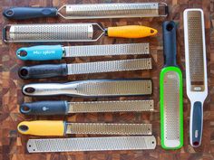 the kitchen utensils are lined up on the table with different types of knives