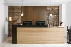 the front desk of a modern office with wood paneling