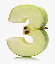 the letter e is cut in half and ready to be eaten by someone with an apple