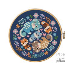 a cross stitch pattern with an elephant and other animals in the center on a blue background