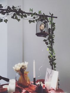 a table with candles, flowers and pictures on it