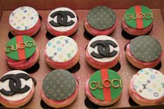 cupcakes in a box decorated with gucci logo and monogram on them