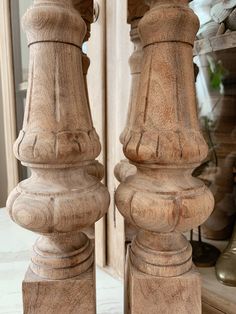 two wooden pillars are standing next to each other