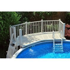 an above ground swimming pool with stairs leading to the top and bottom decking area