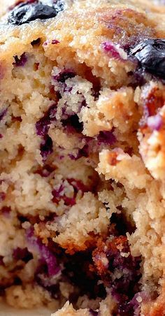 a close up of a blueberry muffin on a plate