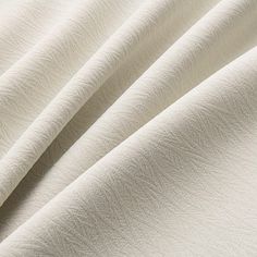 closeup of white fabric textured with soft folds and lines on an unbuttoned background