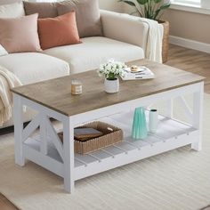 a living room with a white couch and coffee table