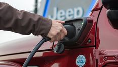 a man is pumping gas into his car