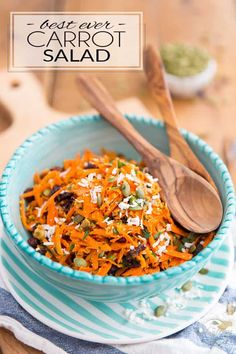 a blue bowl filled with carrot salad on top of a table