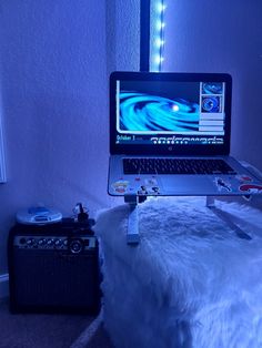 a laptop computer sitting on top of a white fur covered ottoman in front of a mirror