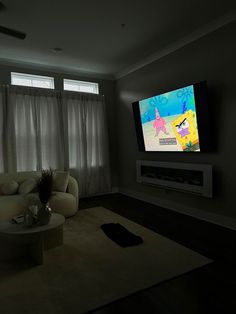 a large flat screen tv mounted to the side of a wall in a living room