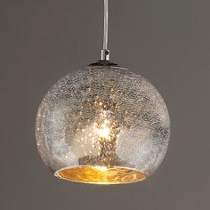 a glass ball light hanging from a ceiling