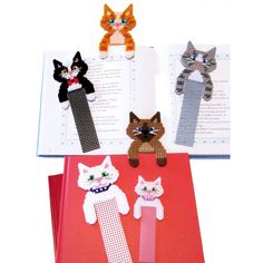 an open book with four cats on it