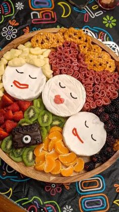 a wooden bowl filled with fruit and snacks