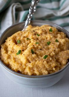 a bowl filled with mashed potatoes on top of a table