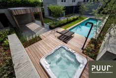 a hot tub sitting on top of a wooden deck next to a swimming pool in the middle of a yard