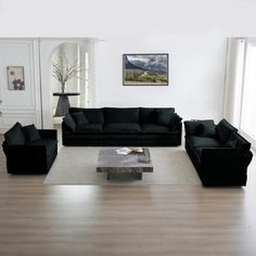 a living room filled with black couches and chairs