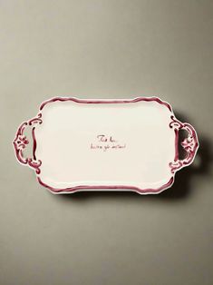 a white and red tray with writing on it