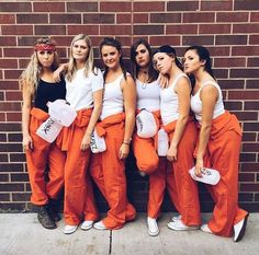 several women in orange pants and white shirts