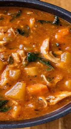 a bowl filled with soup on top of a wooden table