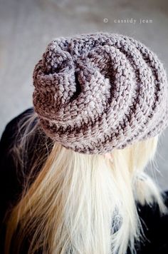 a woman with blonde hair wearing a crochet knitted beanie on top of her head