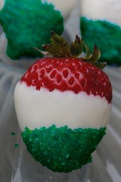 there is a green, white and red strawberries ornament