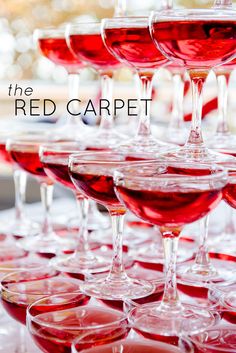 many wine glasses are lined up on a table with the words, the red carpet