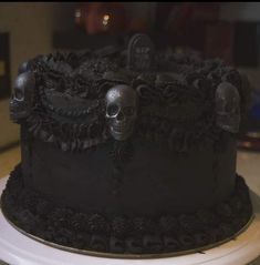 there is a black cake with skulls on it